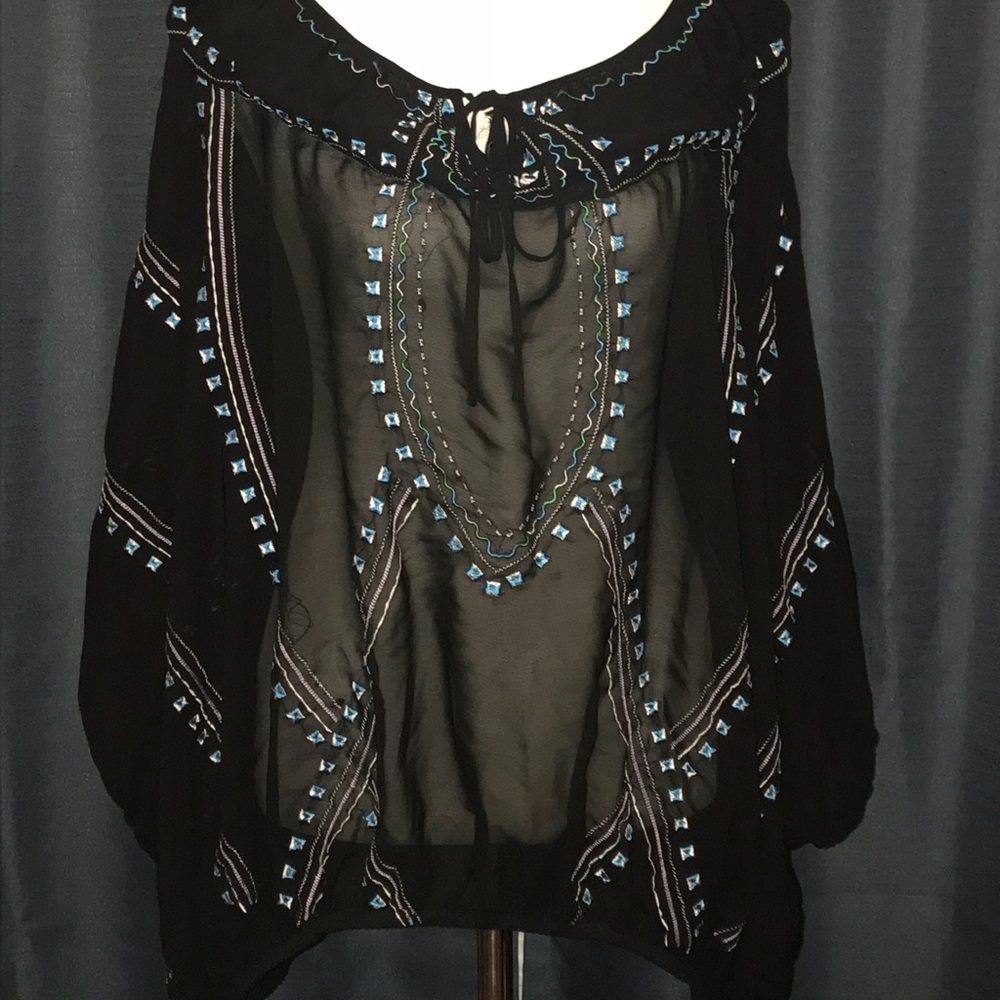 Sheer black blouse with embroidered details
